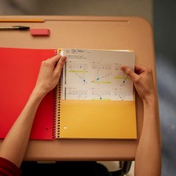 Student pulling papers out of a folder